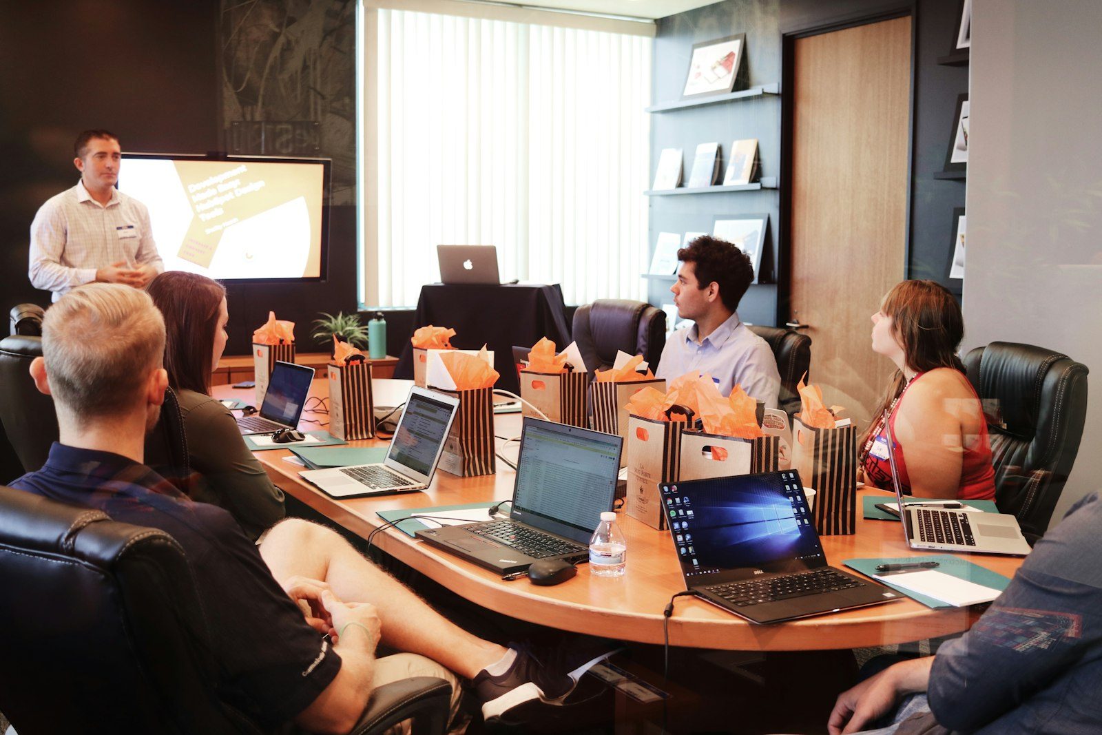 A manager presenting to a team in a boardroom