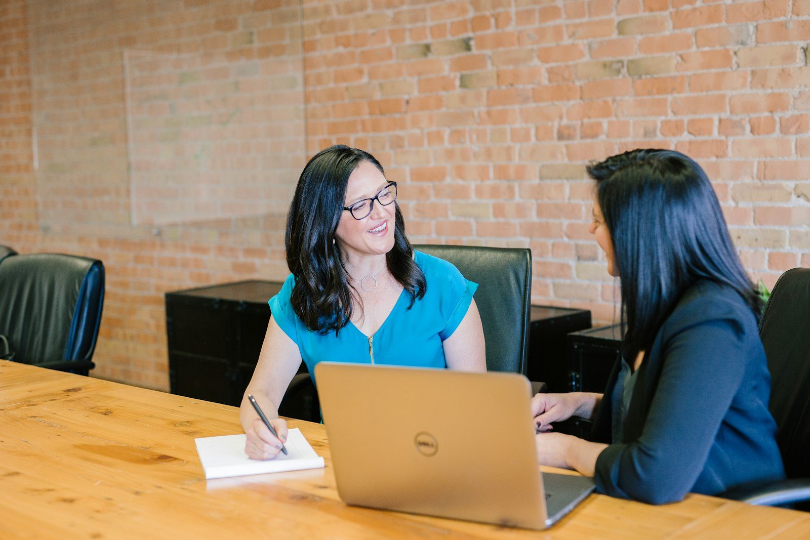 A coach and client in conversation across a table