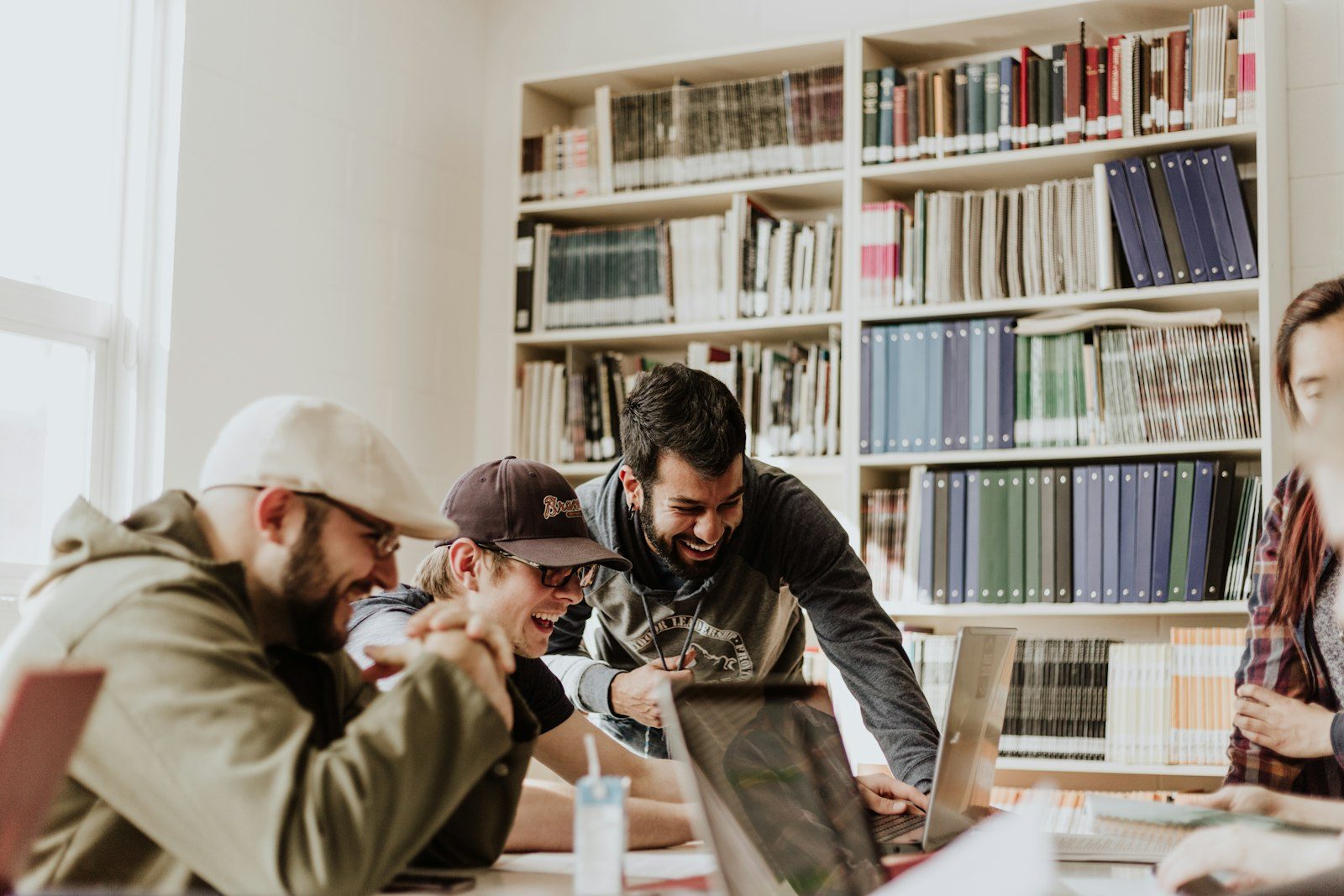 Researchers working between library shelves