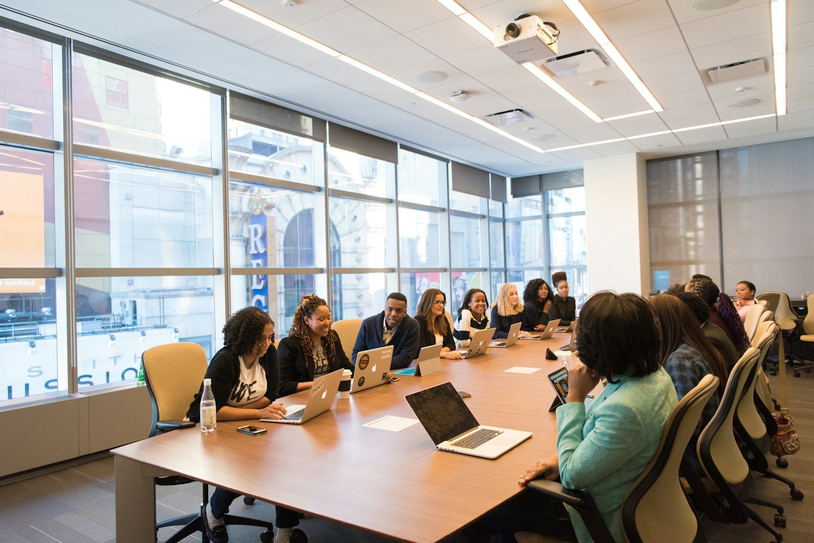 A leadership team in a glass-walled meeting room