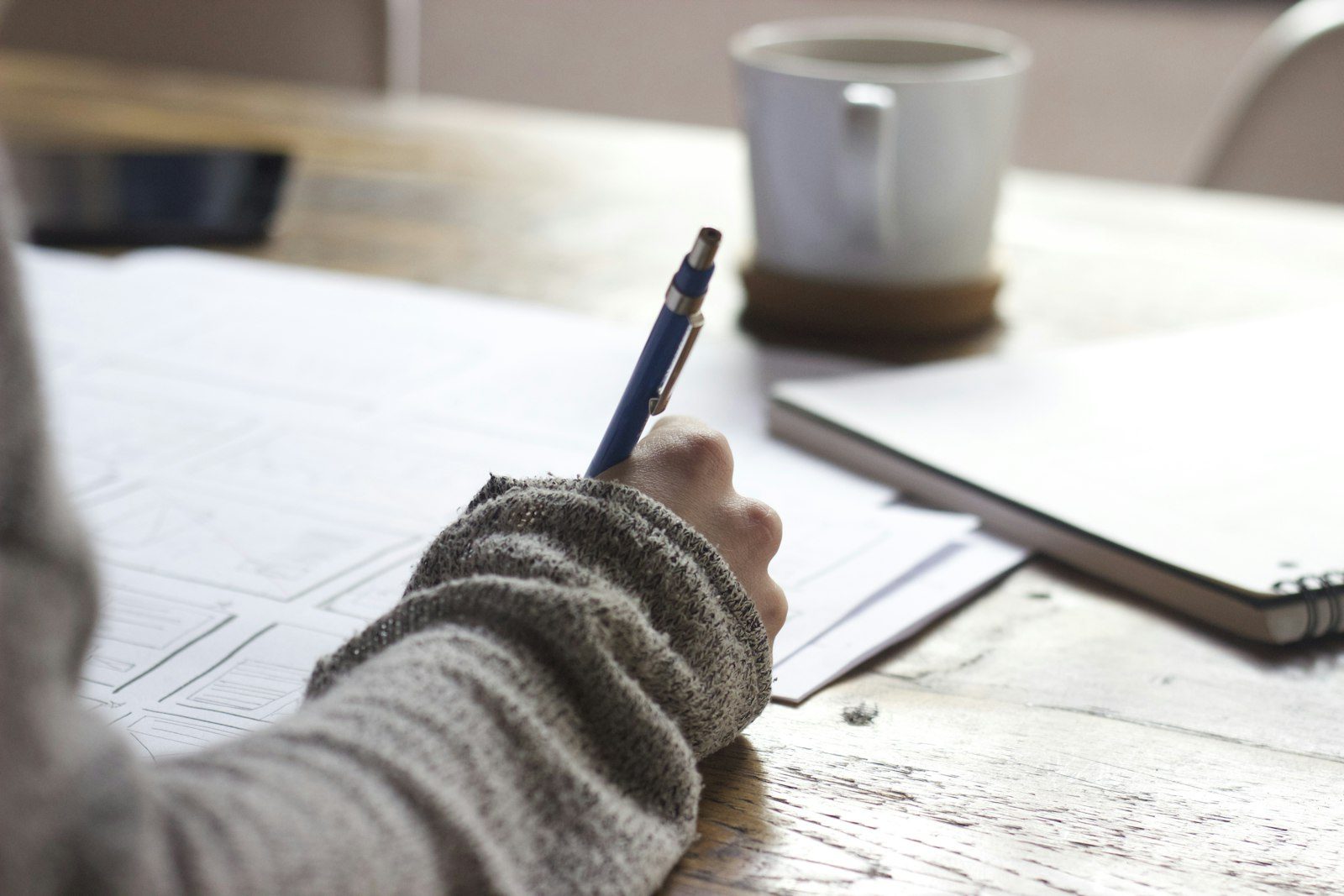 A hand annotating a research questionnaire